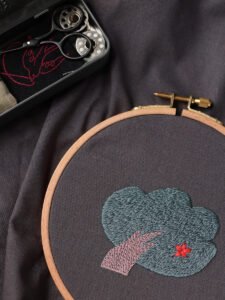 Work-in-progress shot of the embroidered tree from 'Shelter from the Rain' stretched in a wooden embroidery hoop.